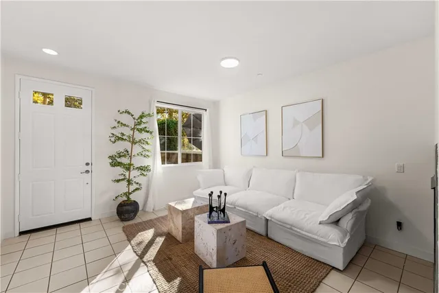 a living room with furniture and a potted plant