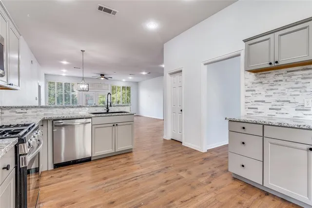 a kitchen with granite countertop white cabinets and white appliances