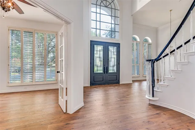 a view of an entryway with wooden floor and windows