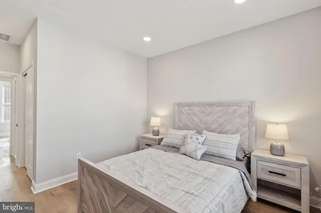 a bedroom with a bed and a lamp