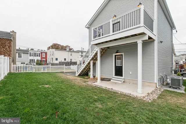 a view of a house with a yard and deck