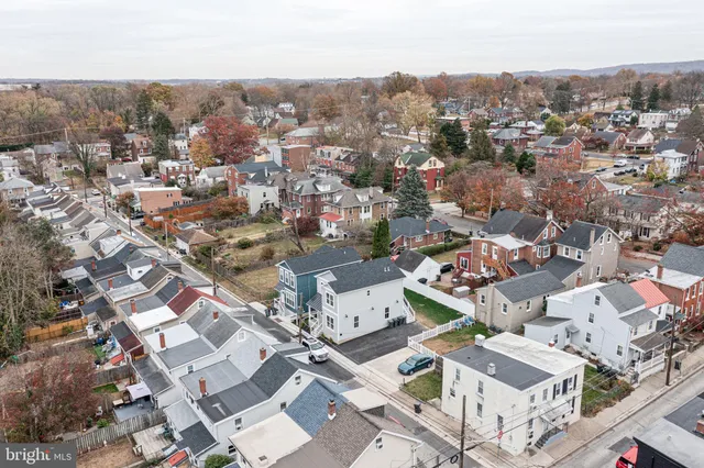 an aerial view of residential houses with city view