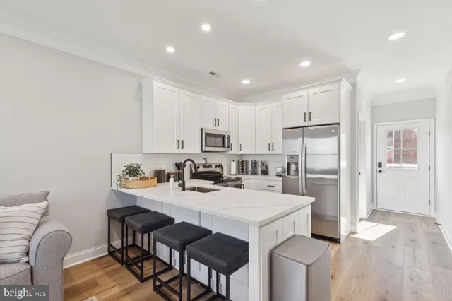 a kitchen with refrigerator and cabinets