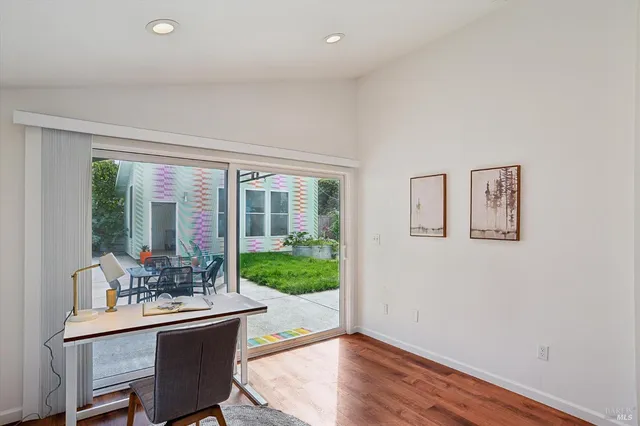 a dining room with furniture a chandelier and glass door
