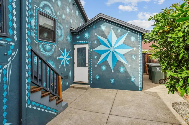 a backyard of a house with outdoor seating