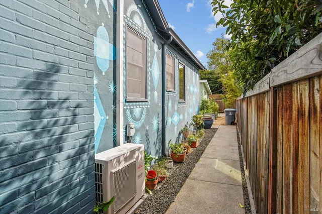 a view of a chair and table in backyard of the house