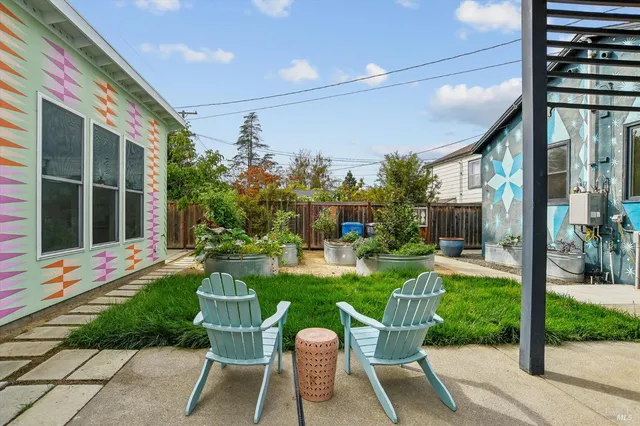 a view of a house with sitting area and garden
