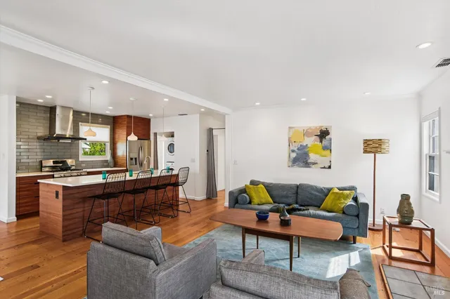 a living room with furniture and a kitchen view
