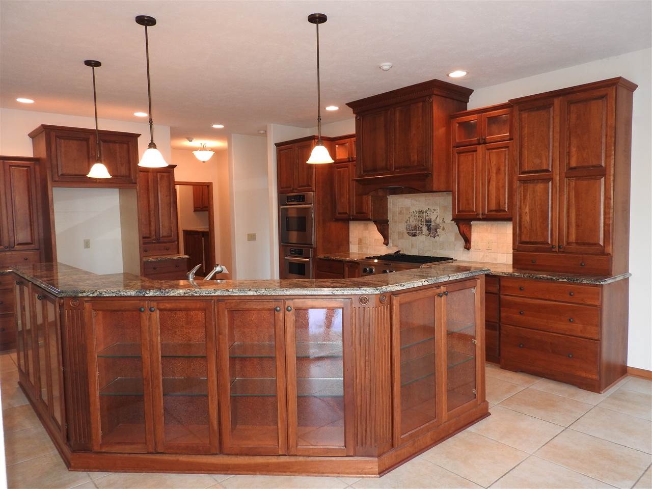 1917 Baintree Road Lake Summerset, IL 61019 - Photo 3 of 25 a kitchen with stainless steel appliances granite countertop wooden cabinets a stove a sink and a wooden floors