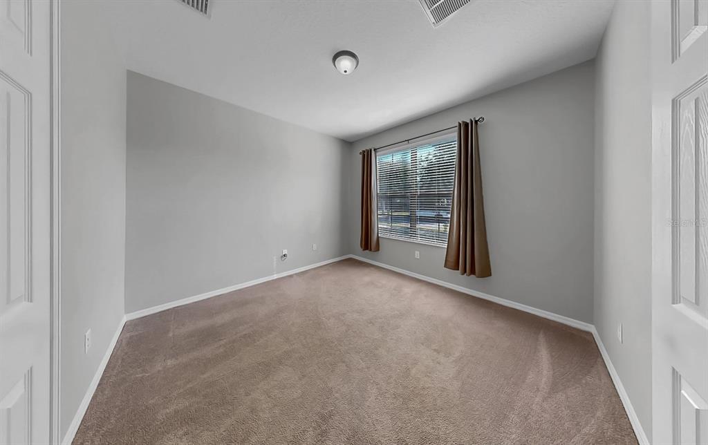 7109 Spindle Tree Lane Riverview, FL 33578 - Photo 14 of 42 an empty room with windows