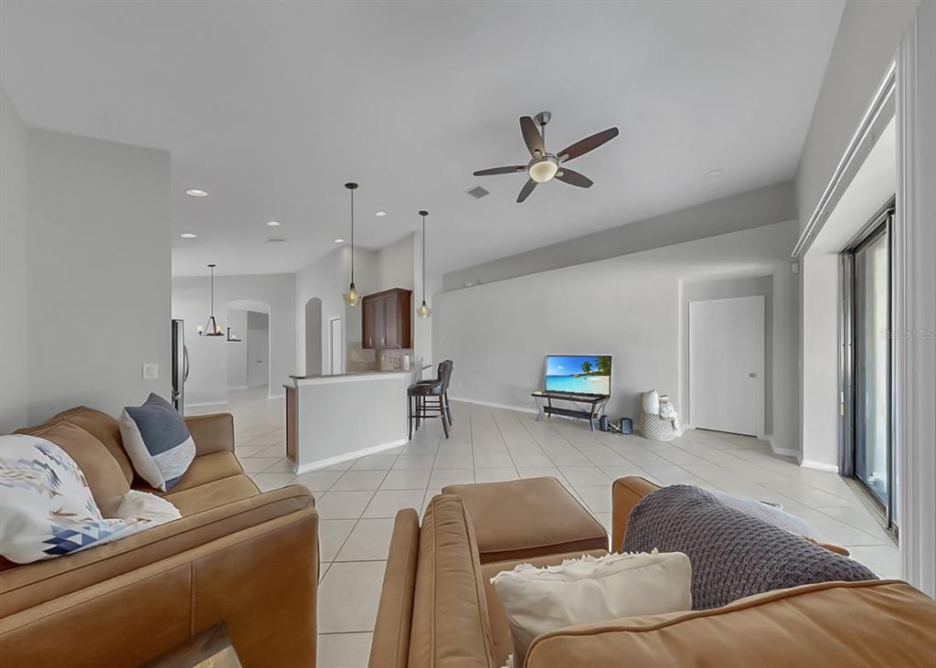 7109 Spindle Tree Lane Riverview, FL 33578 - Photo 25 of 42 a living room with furniture and kitchen view