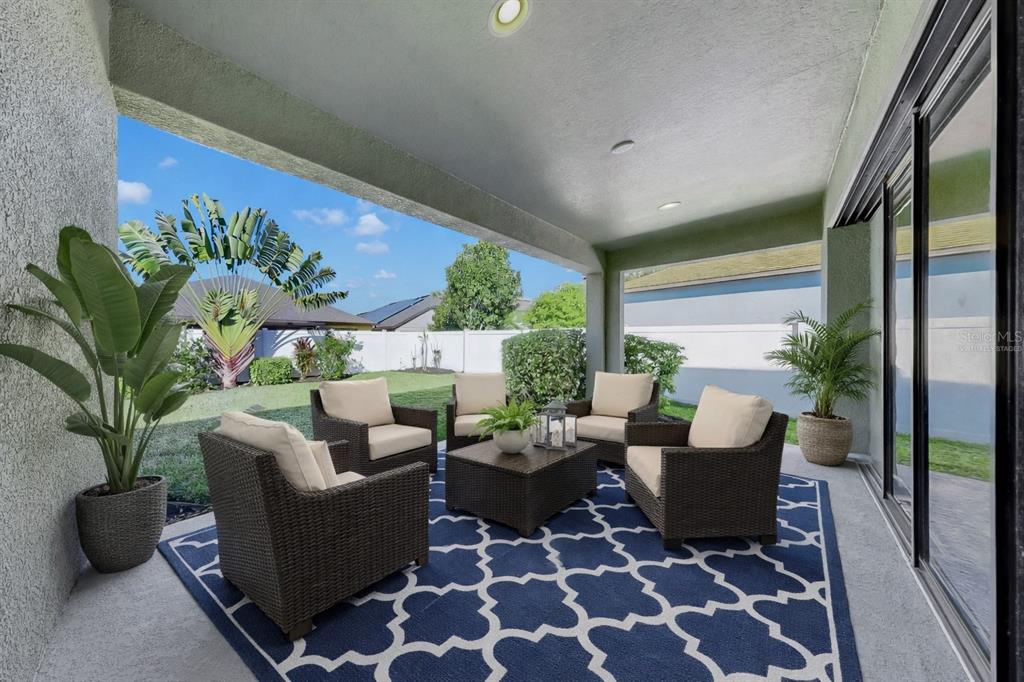 7109 Spindle Tree Lane Riverview, FL 33578 - Photo 38 of 42 a living room with furniture potted plant and a large window