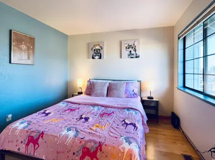 a bedroom with a bed and a window