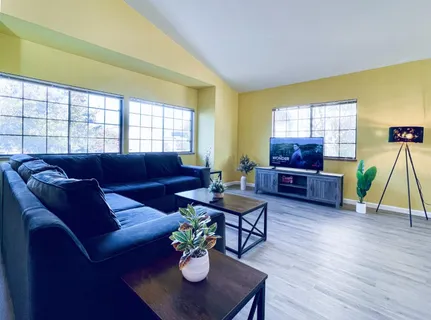 a living room with furniture and a wooden floor