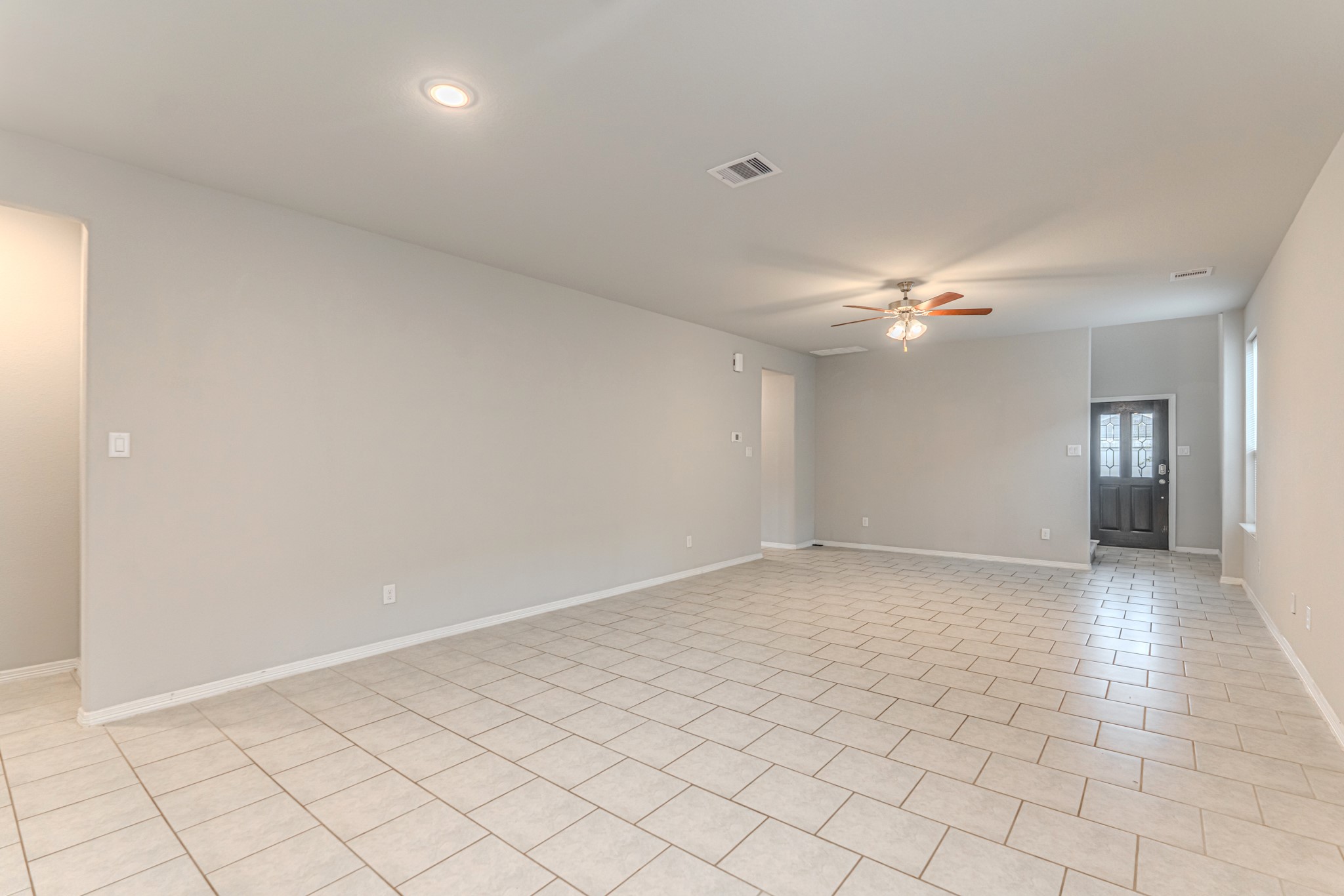 25706 Boxwood Hedge Lane Tomball, TX 77375 - Photo 12 of 44 an empty room with chandelier fan