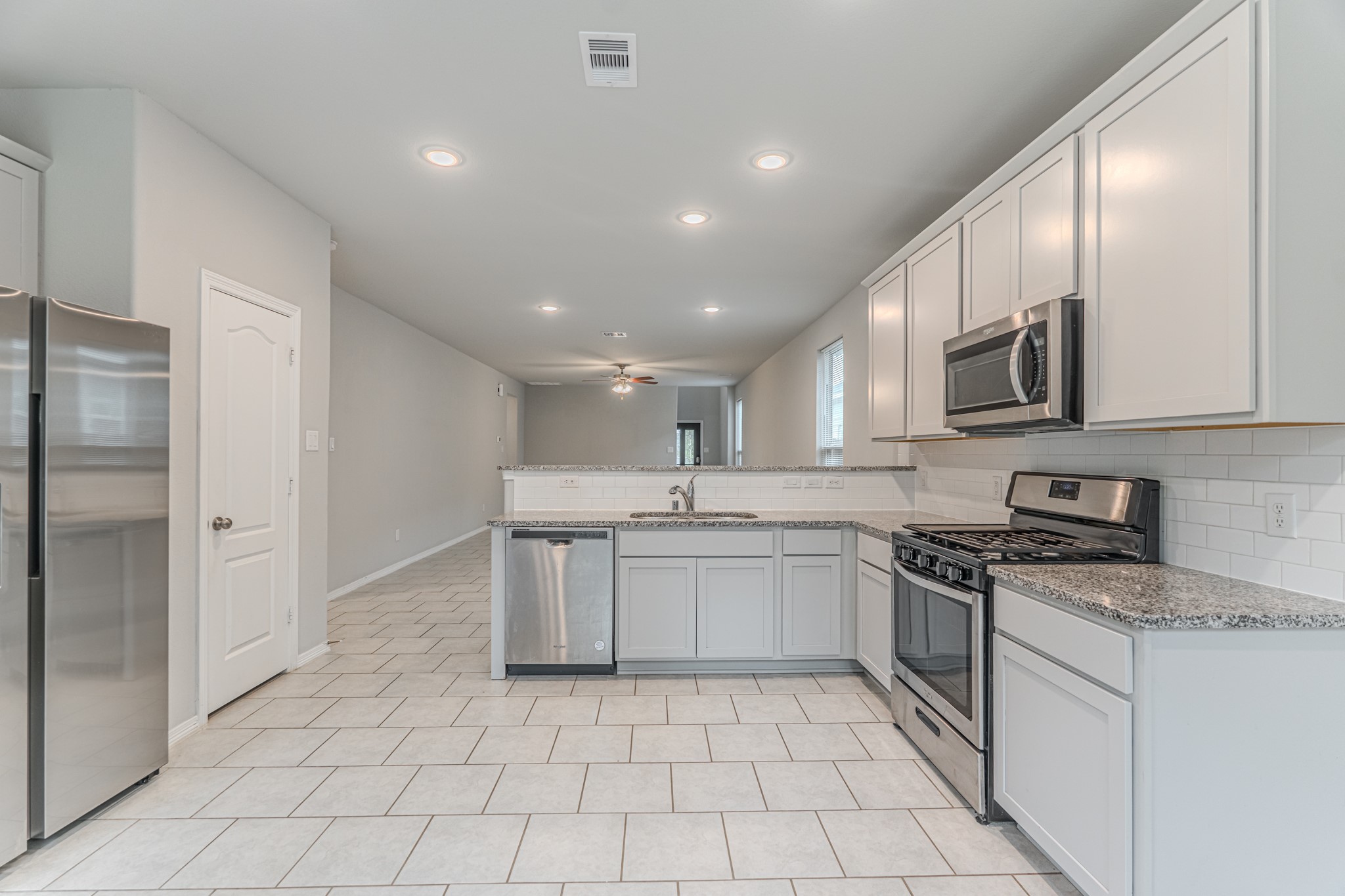 25706 Boxwood Hedge Lane Tomball, TX 77375 - Photo 17 of 44 a kitchen with a sink stainless steel appliances and cabinets