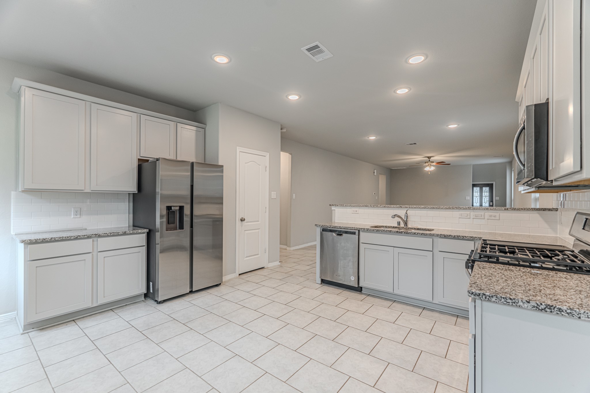 25706 Boxwood Hedge Lane Tomball, TX 77375 - Photo 18 of 44 a kitchen with a sink stainless steel appliances and cabinets