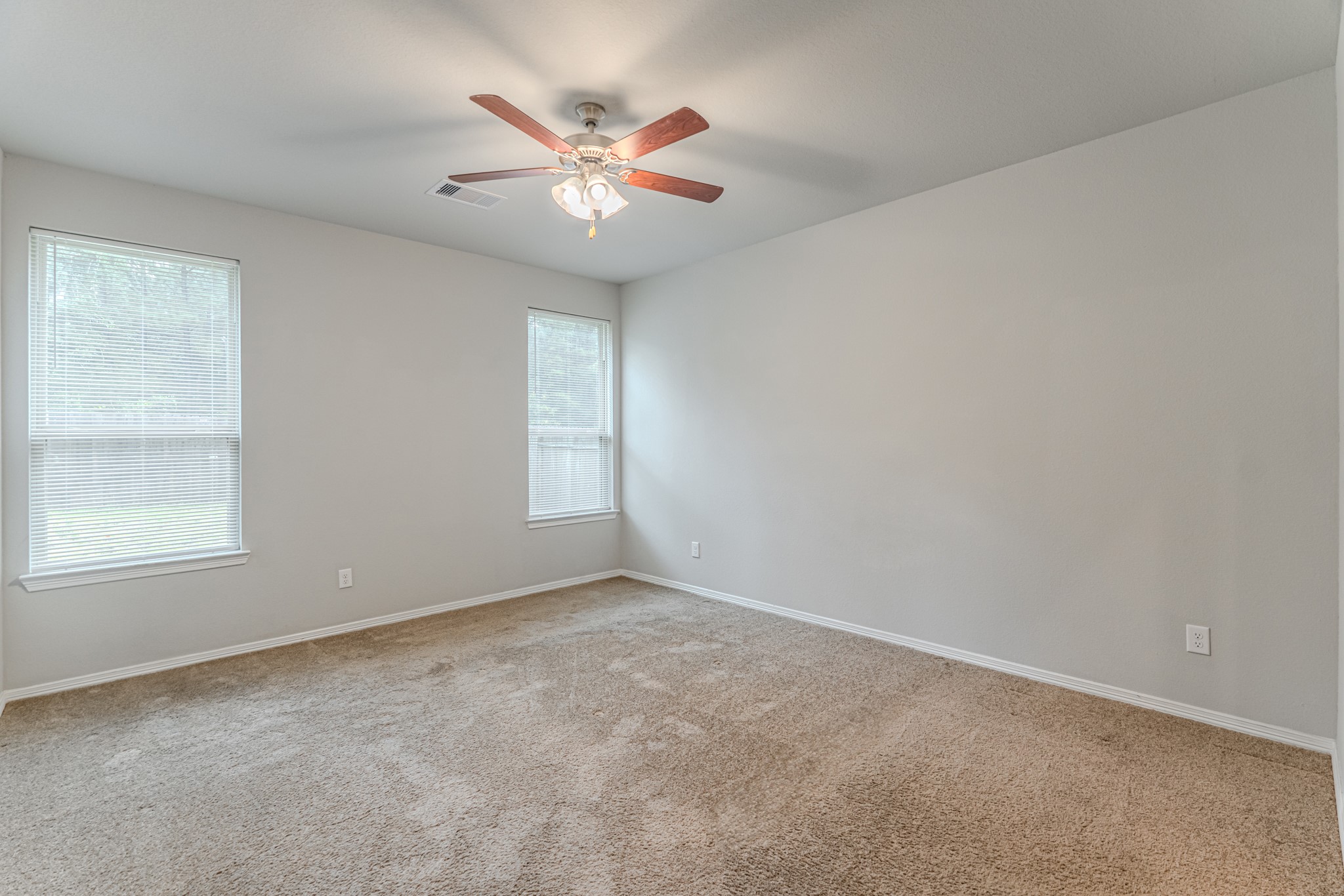 25706 Boxwood Hedge Lane Tomball, TX 77375 - Photo 21 of 44 an empty room with windows and fan