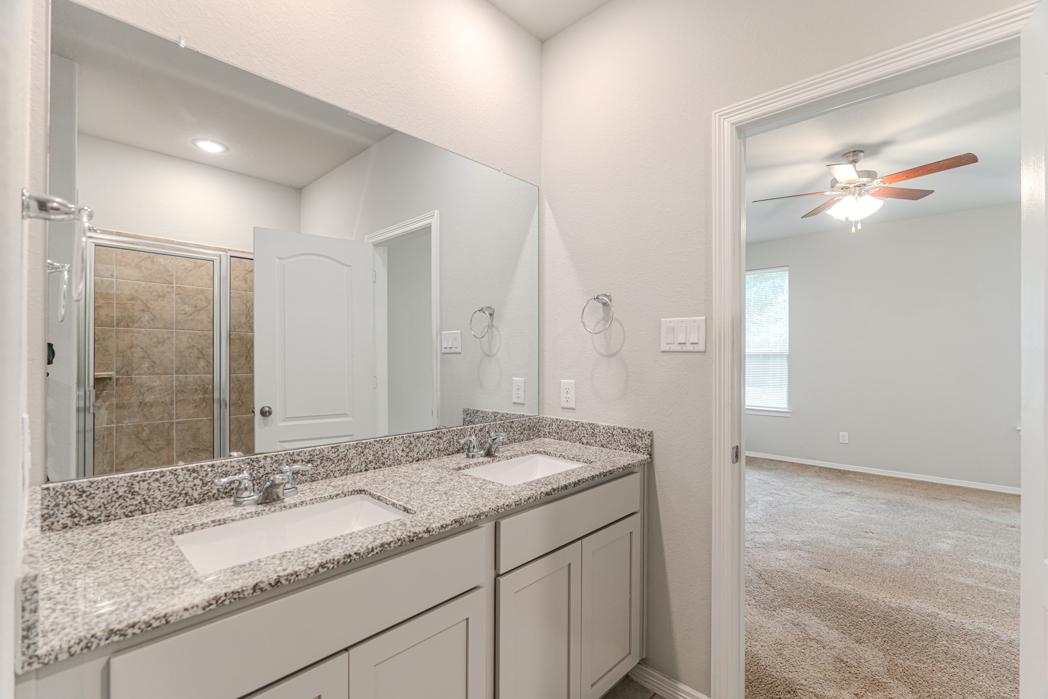 25706 Boxwood Hedge Lane Tomball, TX 77375 - Photo 24 of 44 a bathroom with a granite countertop sink and a mirror