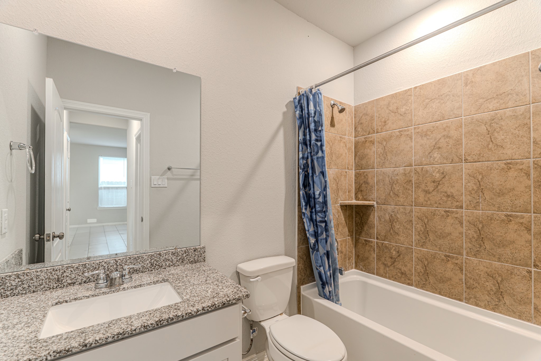 25706 Boxwood Hedge Lane Tomball, TX 77375 - Photo 28 of 44 a bathroom with a granite countertop sink toilet and shower
