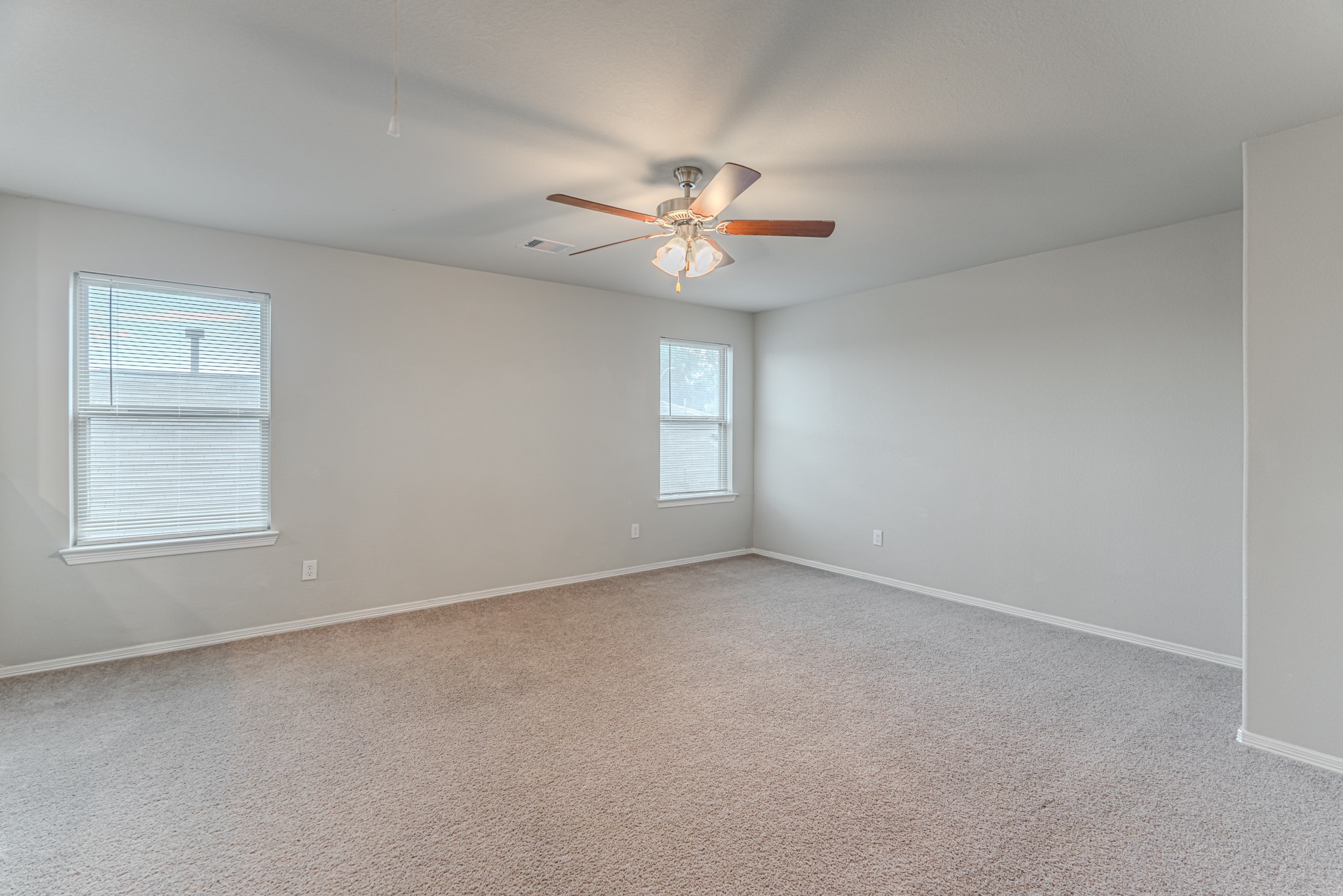 25706 Boxwood Hedge Lane Tomball, TX 77375 - Photo 31 of 44 an empty room with a window and a ceiling fan
