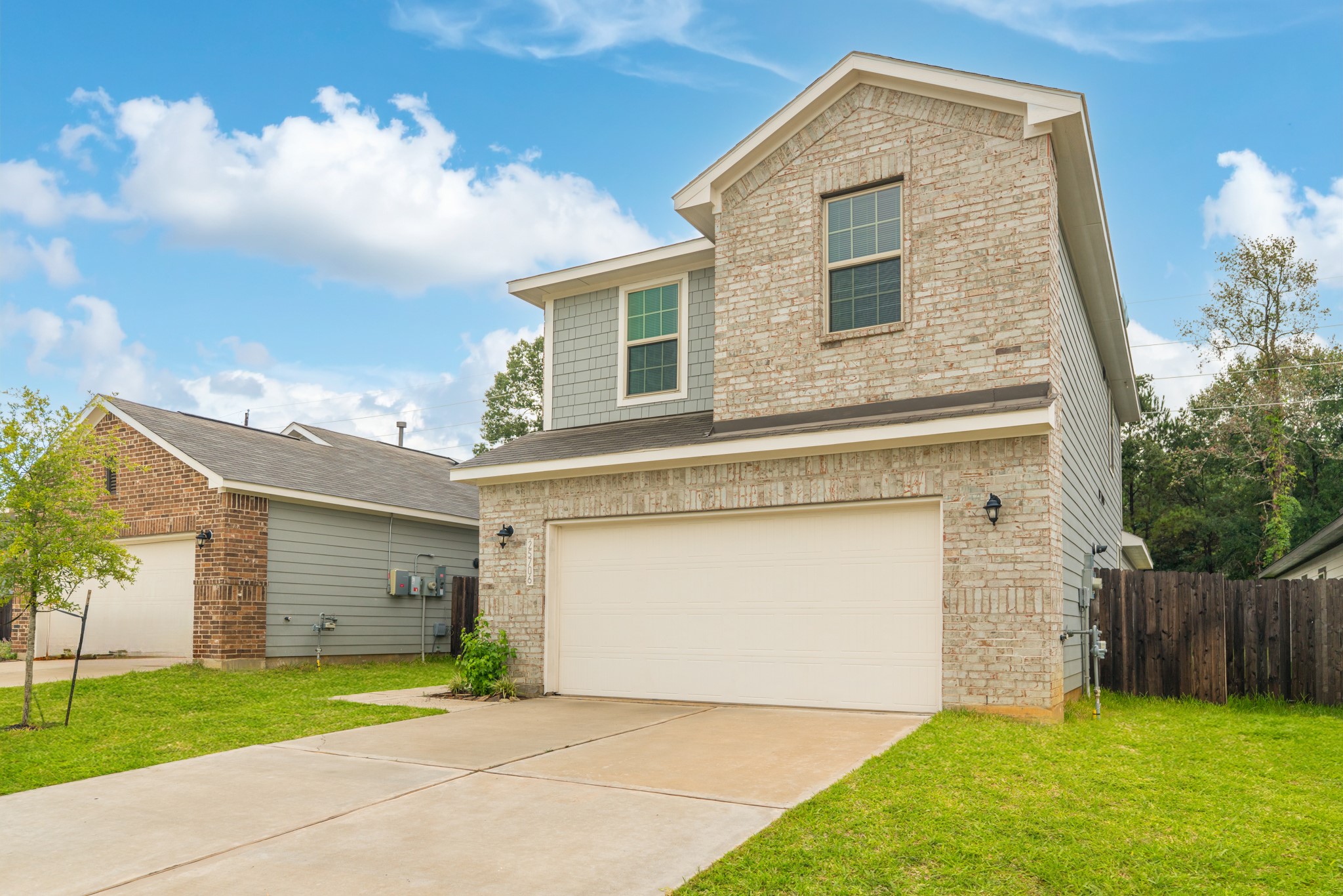 25706 Boxwood Hedge Lane Tomball, TX 77375 - Photo 4 of 44 a front view of a house with a yard and garage