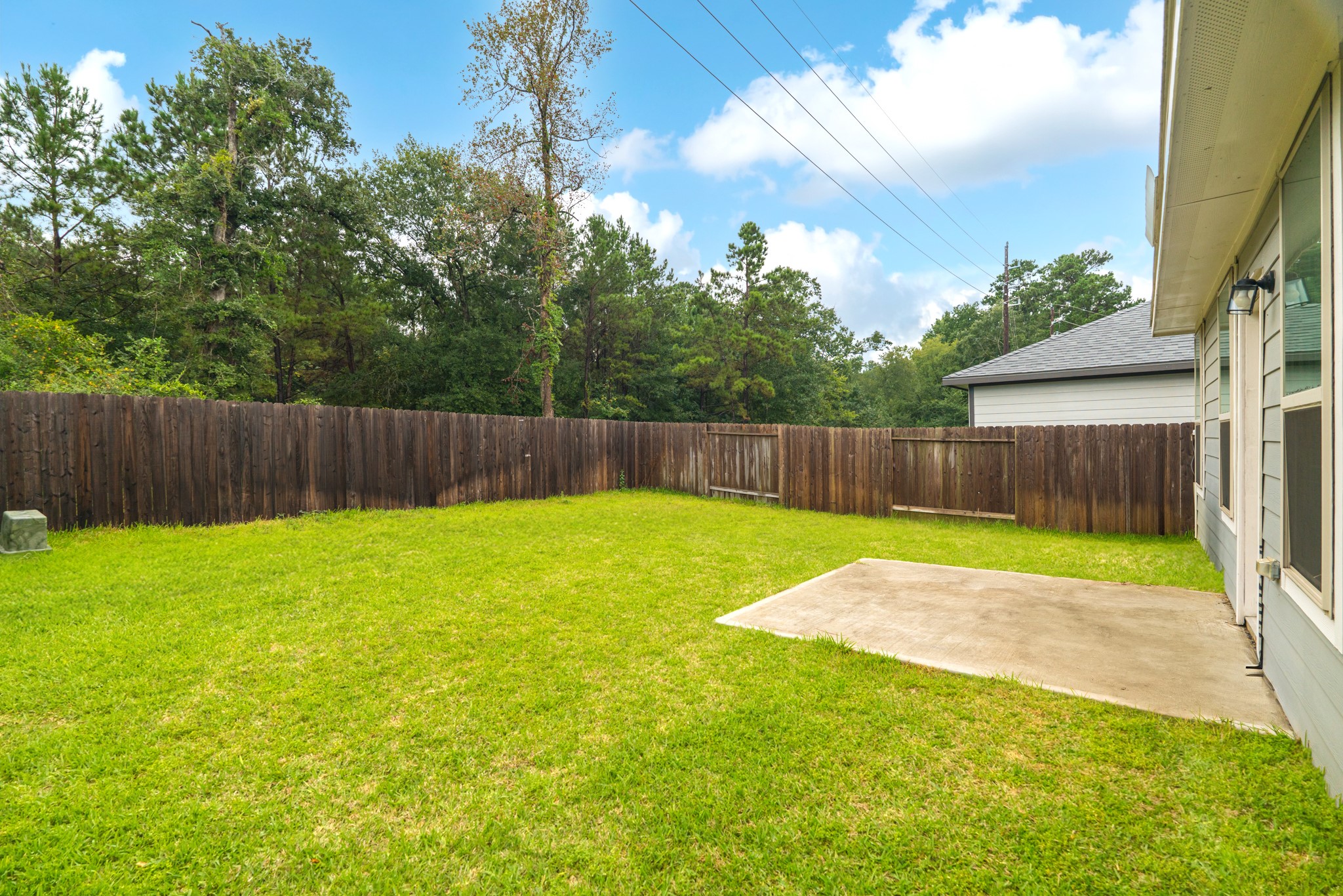25706 Boxwood Hedge Lane Tomball, TX 77375 - Photo 43 of 44 a view of a backyard with swimming pool and wooden fence