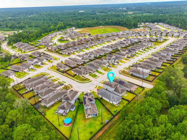 an aerial view of residential houses with outdoor space