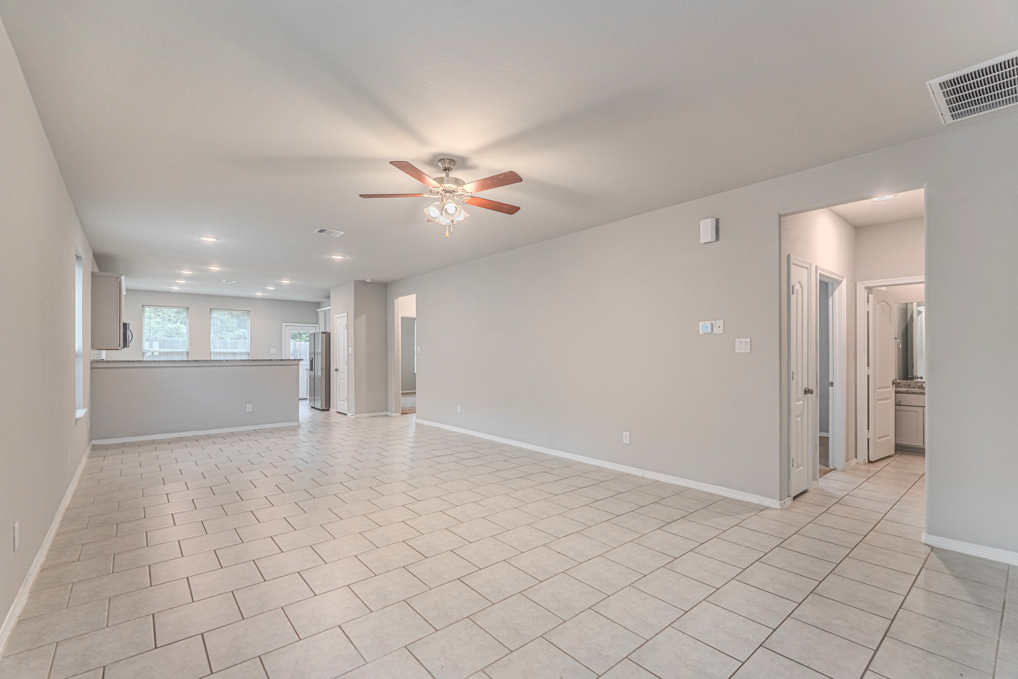 25706 Boxwood Hedge Lane Tomball, TX 77375 - Photo 7 of 44 a view of an empty room and a kitchen