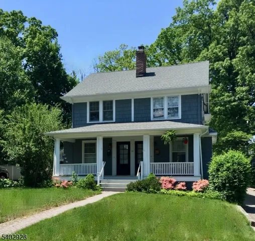 front view of a brick house with a yard