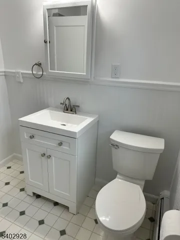 a white toilet sitting next to a bathroom sink