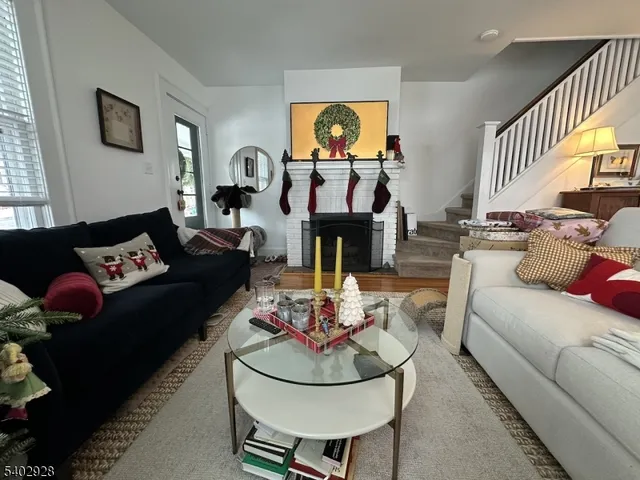 a living room with fireplace furniture and a flat screen tv