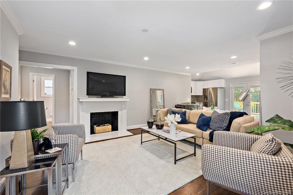 1416 Cortland Road East Charlotte, NC 28209 - Photo 1 of 26 a living room with furniture a fireplace and a flat screen tv