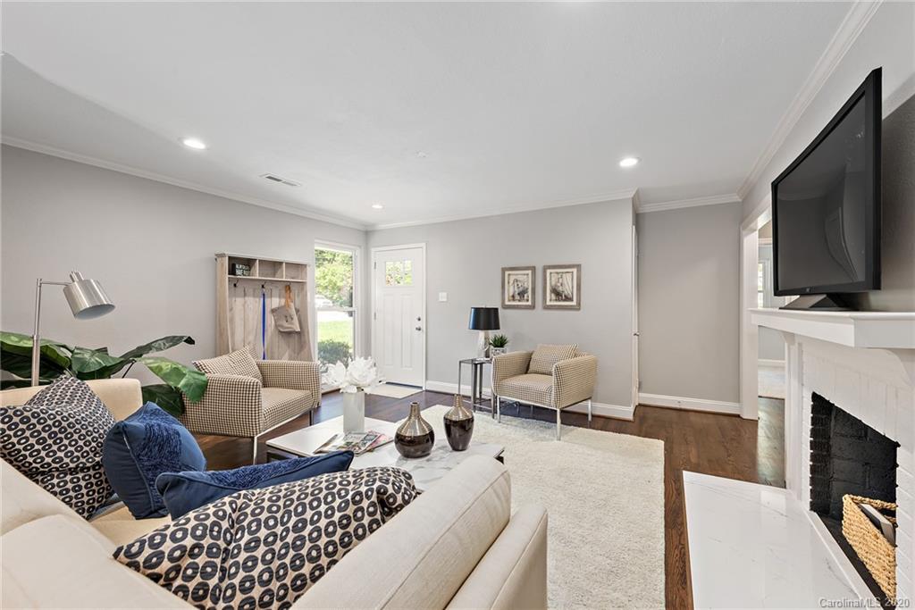 1416 Cortland Road East Charlotte, NC 28209 - Photo 2 of 26 a living room with furniture fireplace and a flat screen tv