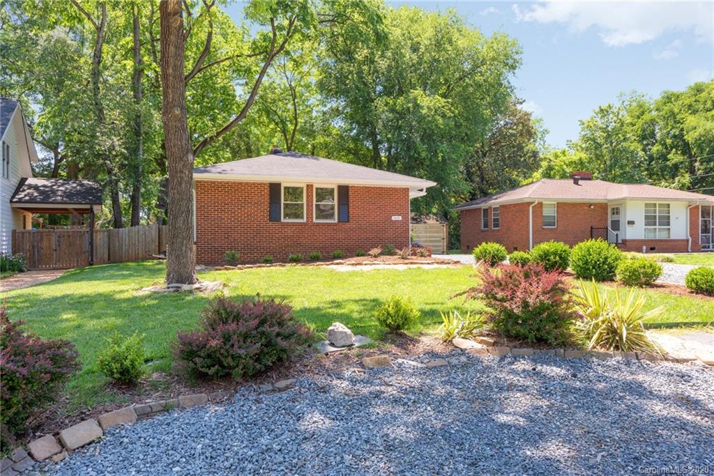 1416 Cortland Road East Charlotte, NC 28209 - Photo 13 of 26 a view of a house with a yard and a garden