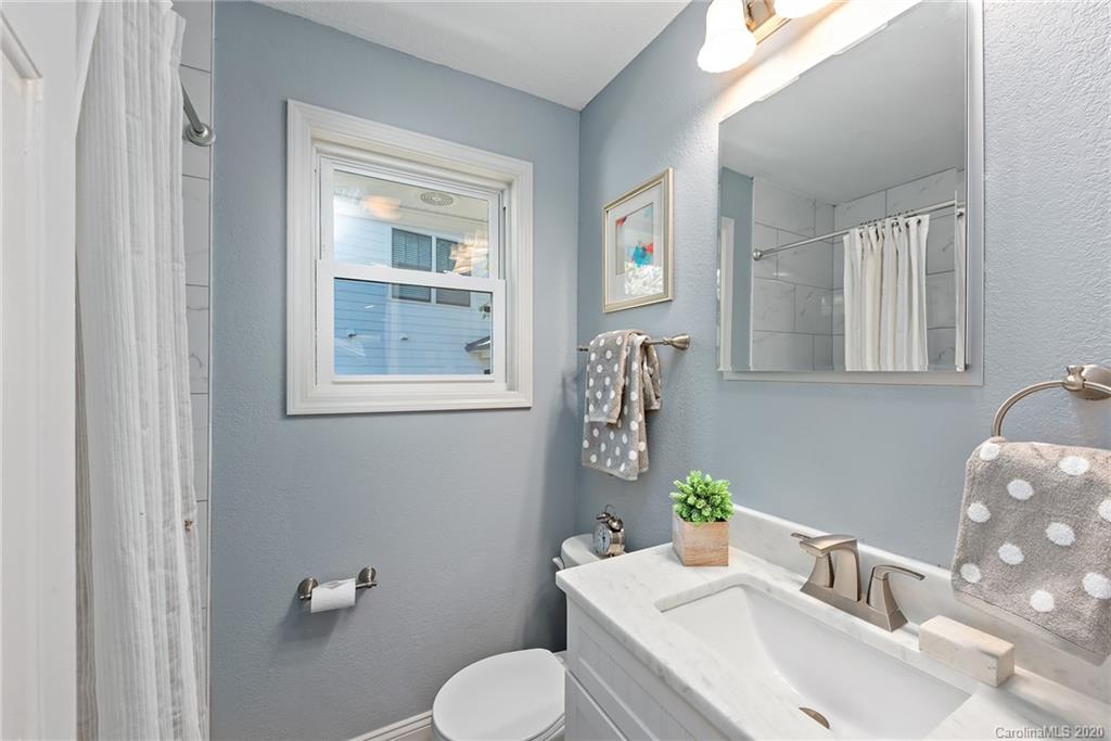 1416 Cortland Road East Charlotte, NC 28209 - Photo 18 of 26 a bathroom with a toilet sink and mirror