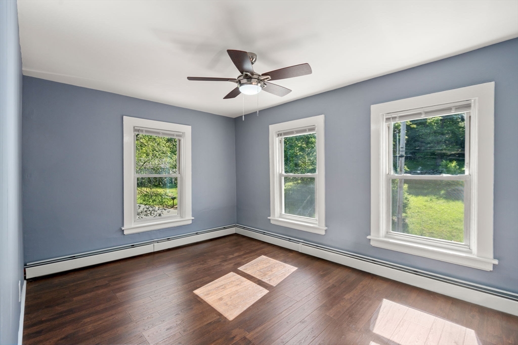 448 Washington Street Warren, MA 01083 - Photo 19 of 42 an empty room with wooden floor and windows