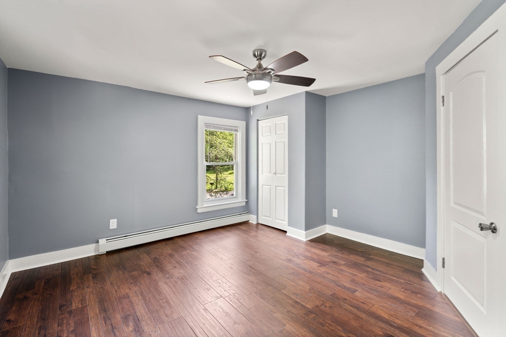 448 Washington Street Warren, MA 01083 - Photo 27 of 42 an empty room with wooden floor a ceiling fan and windows
