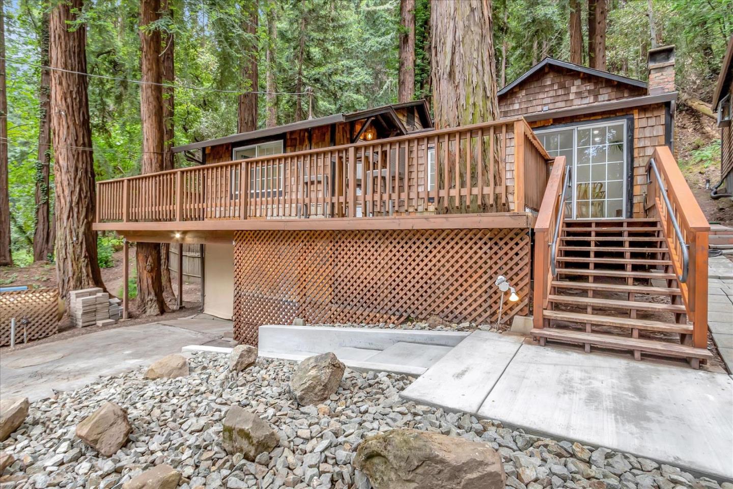 a view of a house with a wooden deck