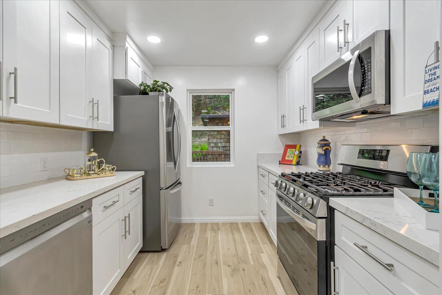 17550 Comanche Trail Los Gatos, CA 95033 - Photo 12 of 37 a kitchen with stainless steel appliances granite countertop a stove a sink and a refrigerator