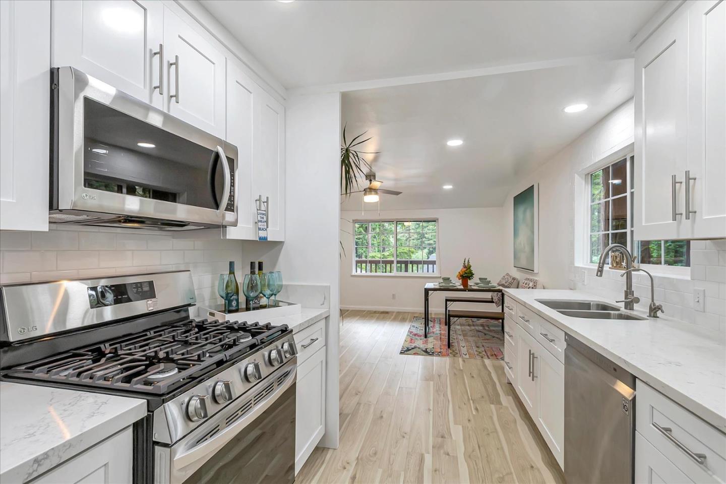 17550 Comanche Trail Los Gatos, CA 95033 - Photo 14 of 37 a kitchen with a stove a sink and a microwave