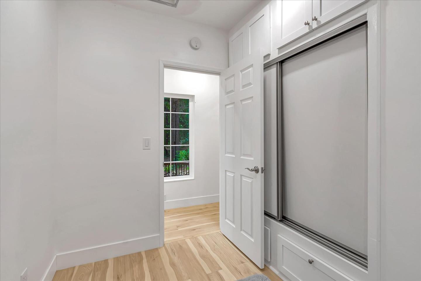 17550 Comanche Trail Los Gatos, CA 95033 - Photo 22 of 37 a view of a hallway with wooden floor and a window