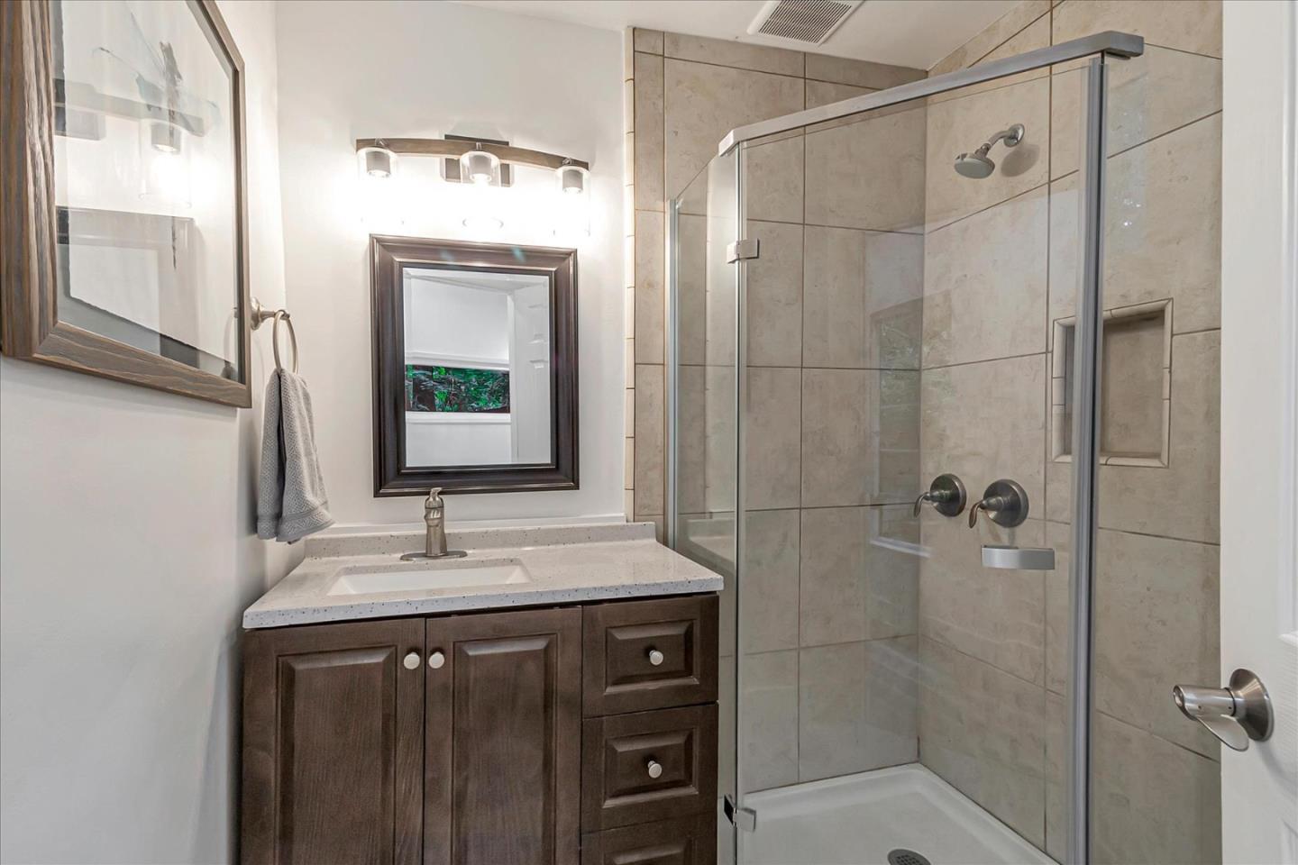 17550 Comanche Trail Los Gatos, CA 95033 - Photo 26 of 37 a bathroom with a shower sink and mirror
