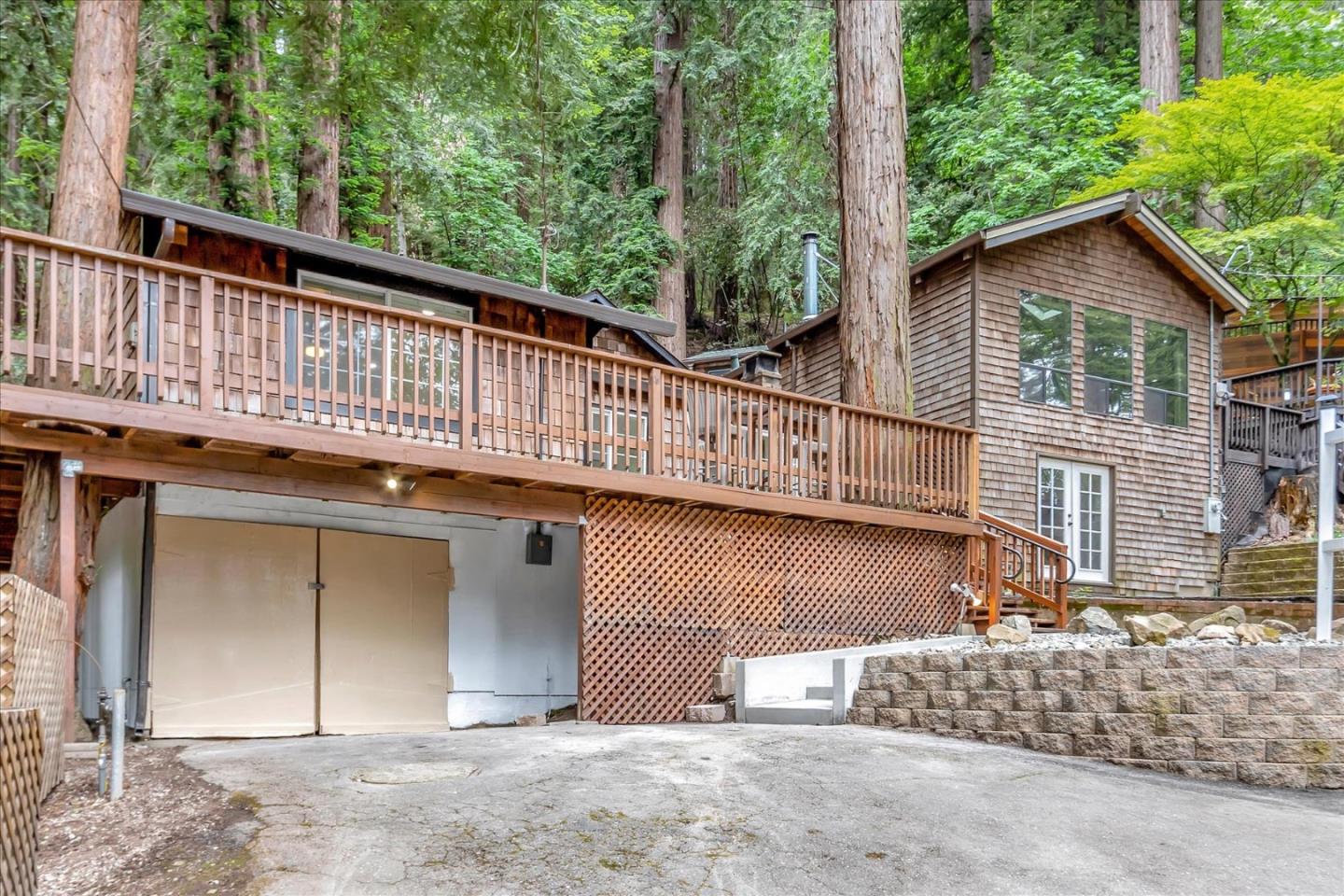 17550 Comanche Trail Los Gatos, CA 95033 - Photo 4 of 37 a view of a house with large windows and a small yard
