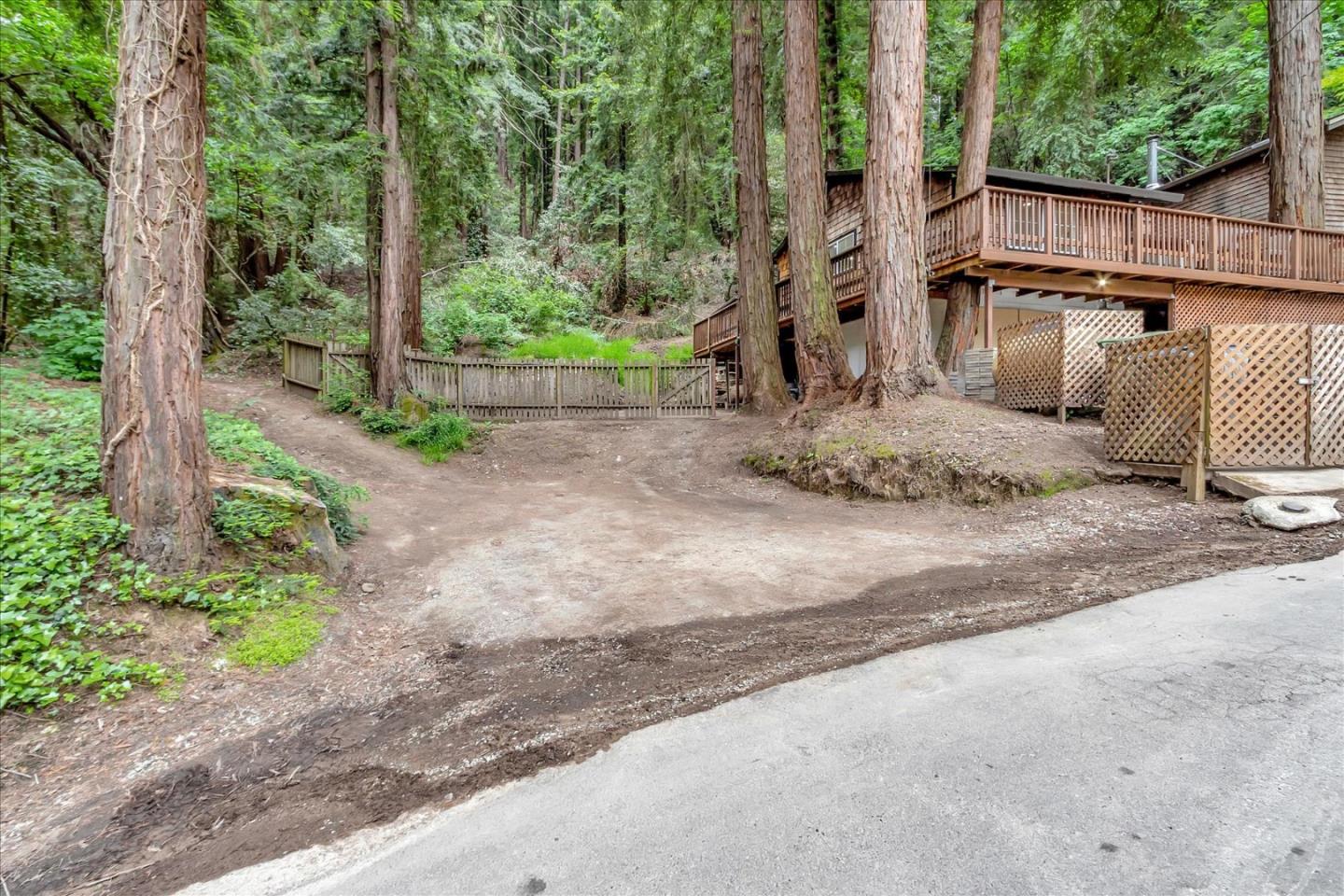 17550 Comanche Trail Los Gatos, CA 95033 - Photo 5 of 37 a view of a backyard with large trees and wooden fence