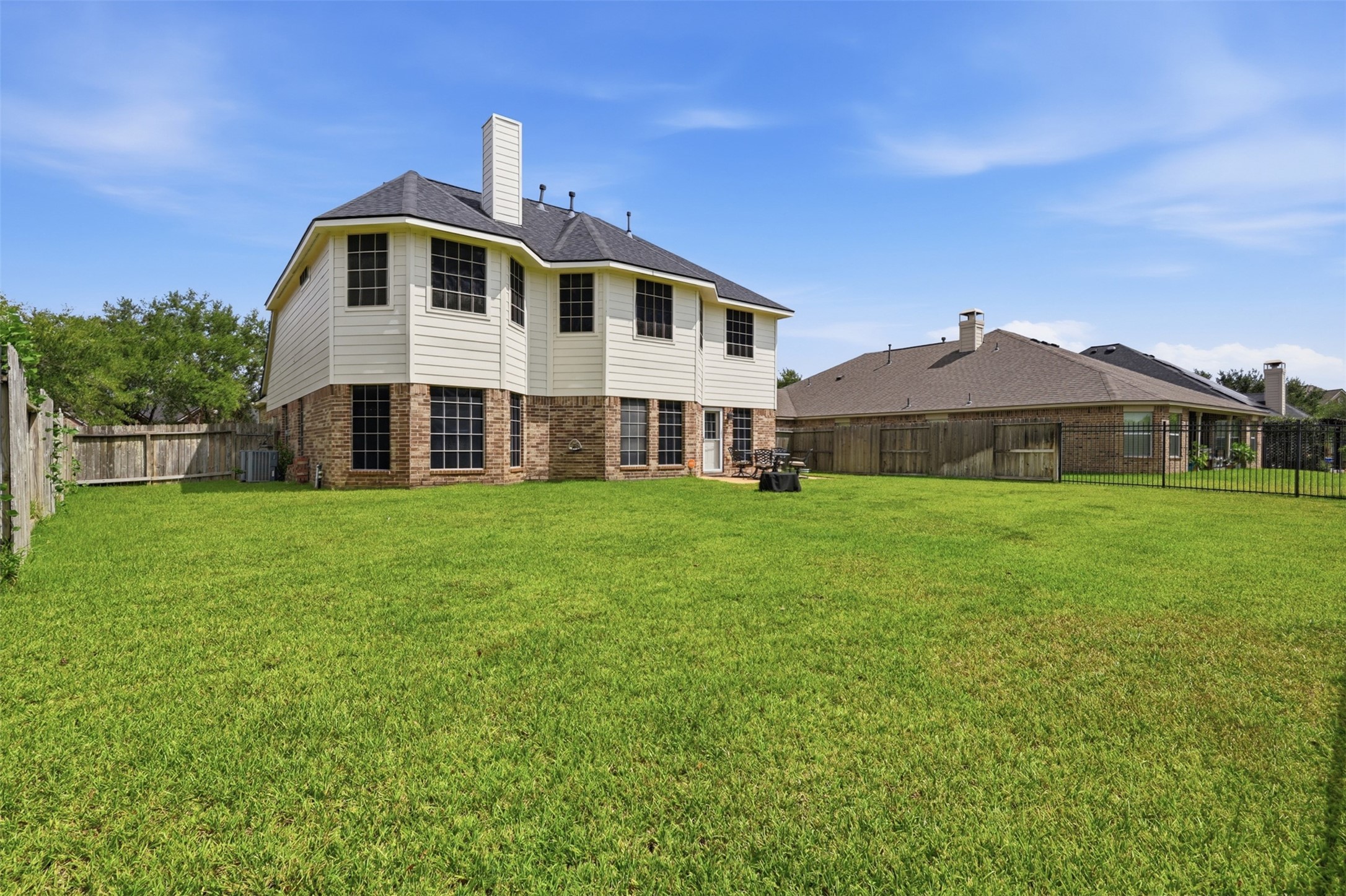 13806 Cove Landing Lane Rosharon, TX 77583 - Photo 35 of 44 The rear exterior showcases a spacious backyard, two-story elevation, and easy access to the outdoor living area.
