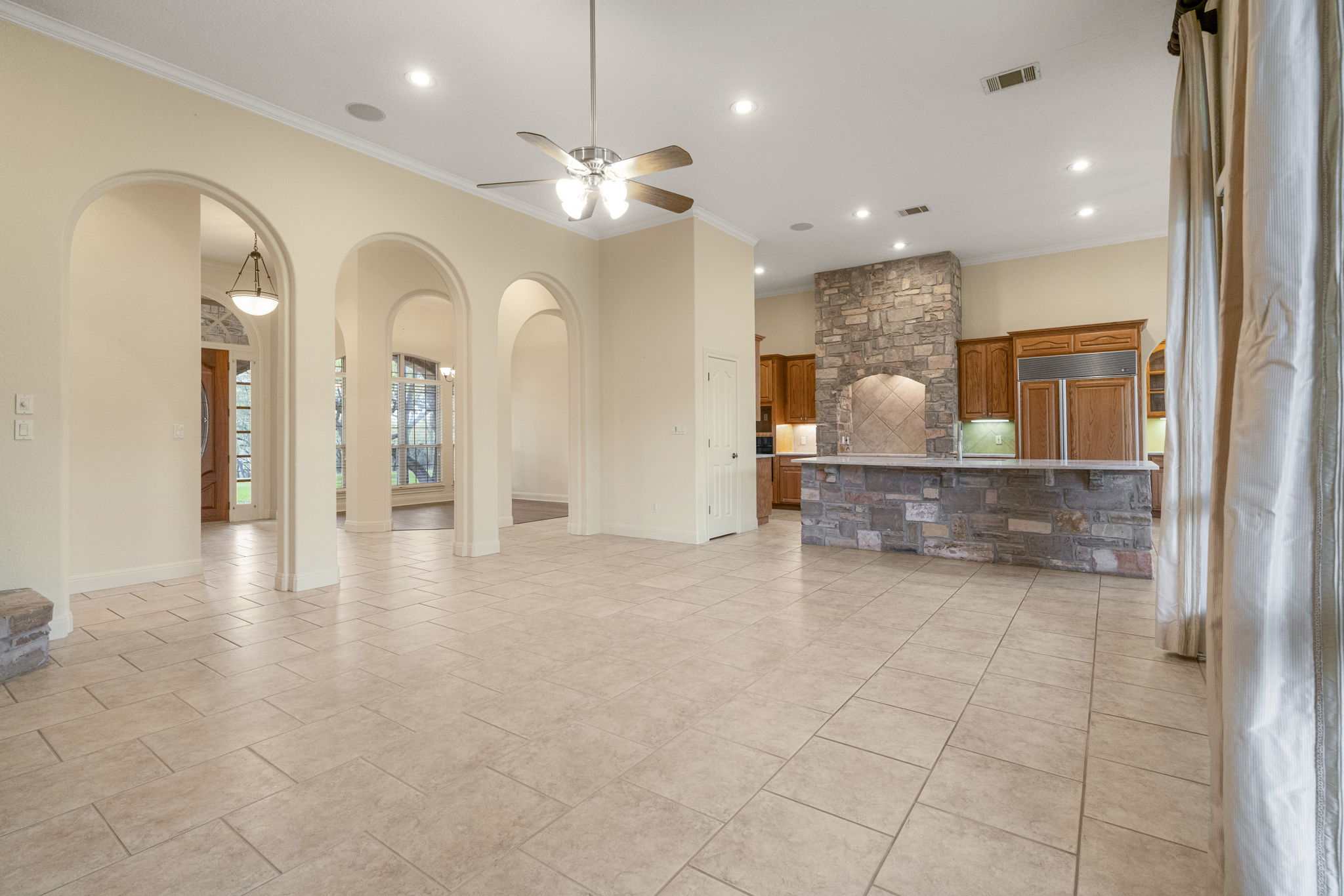 301 Goldridge Drive Georgetown, TX 78633 - Photo 7 of 40 a view of a hallway with chandelier and fireplace