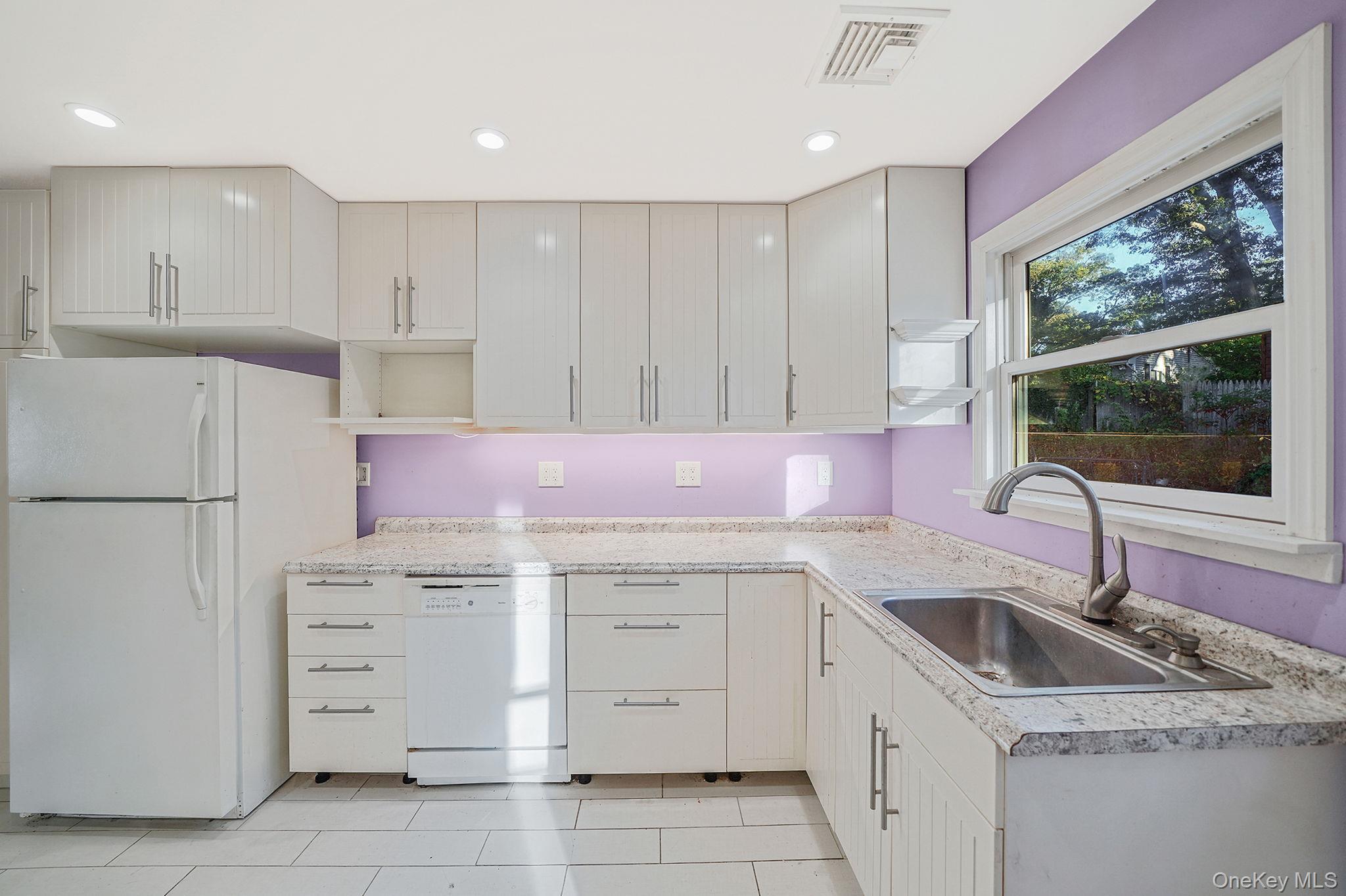 97 Locust Drive Rocky Point, NY 11778 - Photo 14 of 26 Kitchen with white appliances, light countertops, light tile patterned floors, recessed lighting, and open shelves