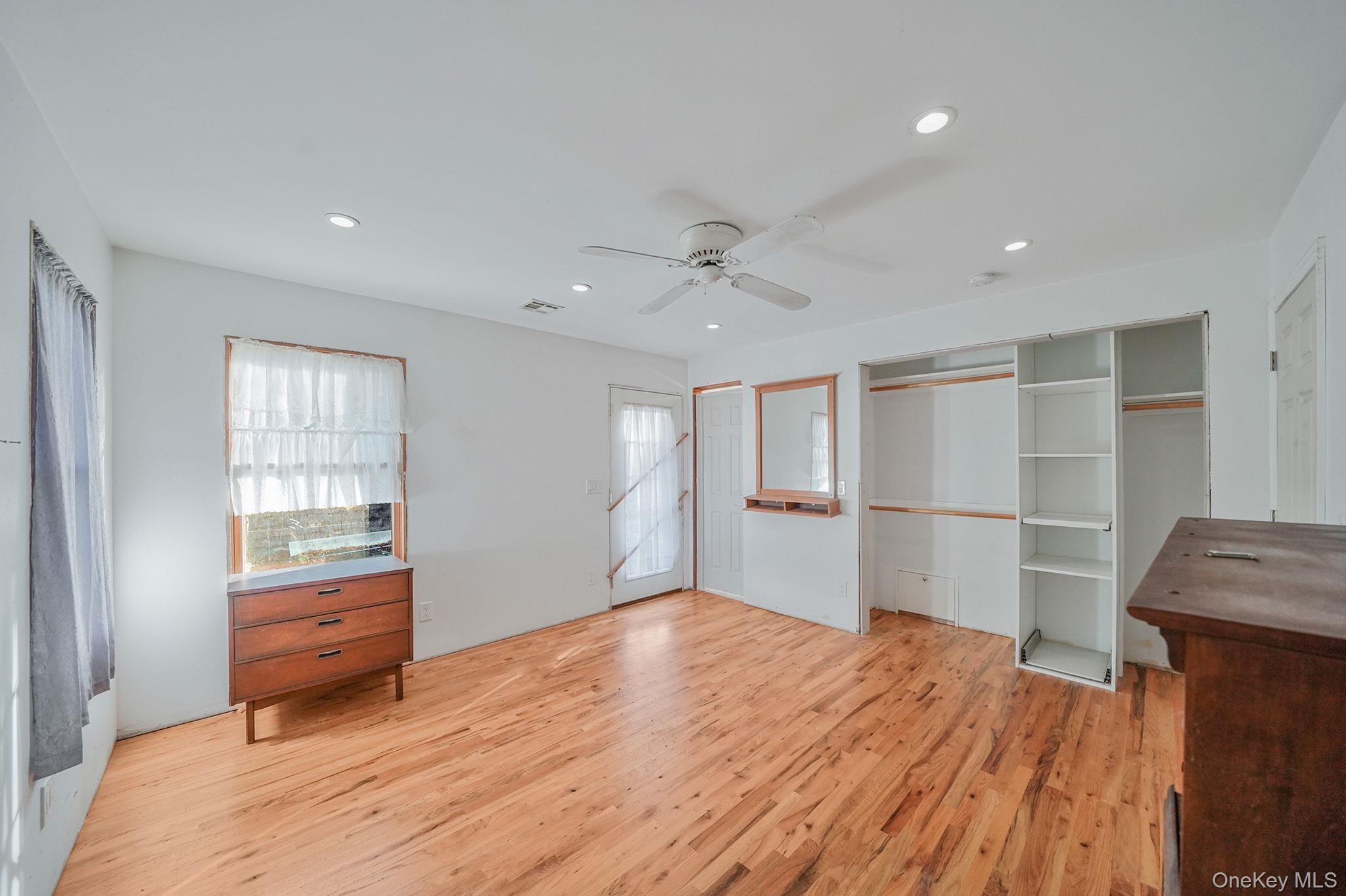 97 Locust Drive Rocky Point, NY 11778 - Photo 15 of 26 Unfurnished bedroom featuring light wood-type flooring, recessed lighting, ceiling fan, and a closet