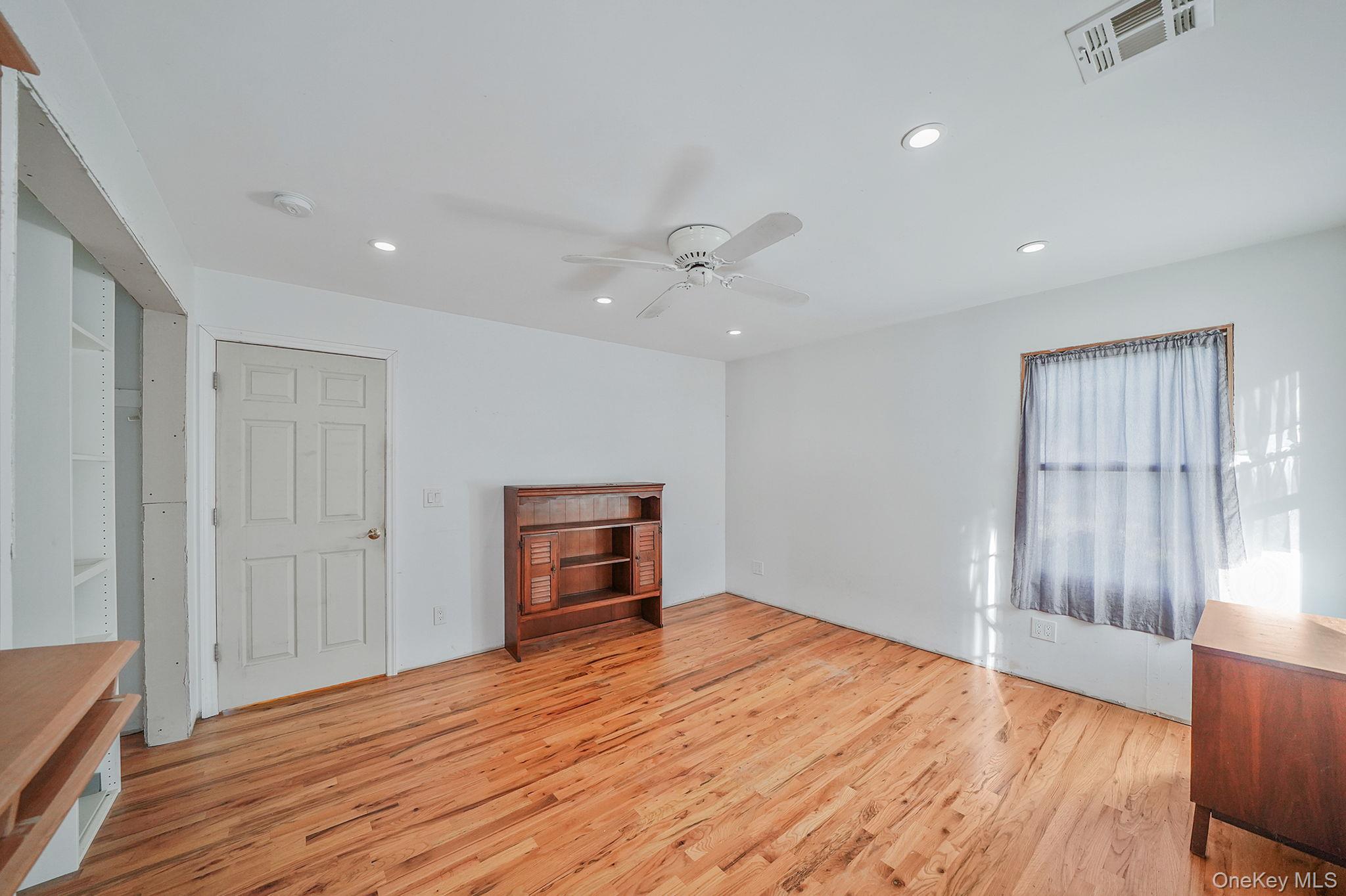 97 Locust Drive Rocky Point, NY 11778 - Photo 16 of 26 Unfurnished living room featuring light wood finished floors, recessed lighting, and ceiling fan